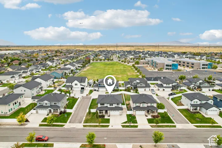 Aerial perspective showcasing a residential development with a prominent green space