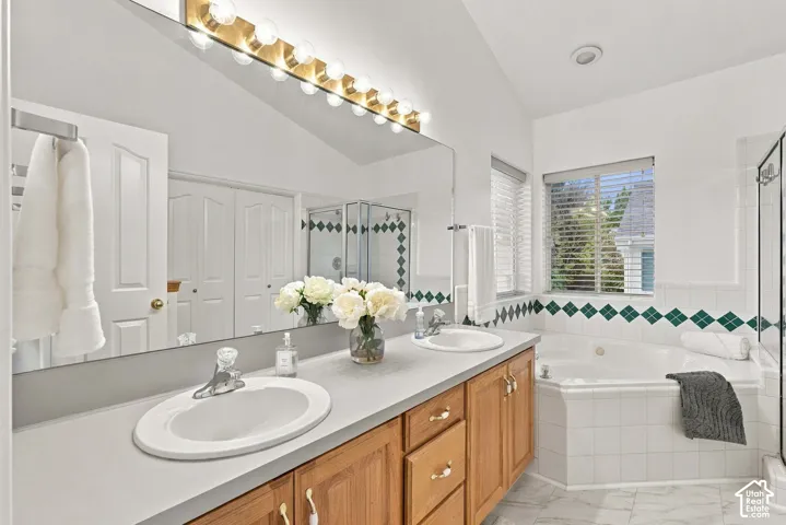 Double vanity and corner jetted tub in primary bedroom