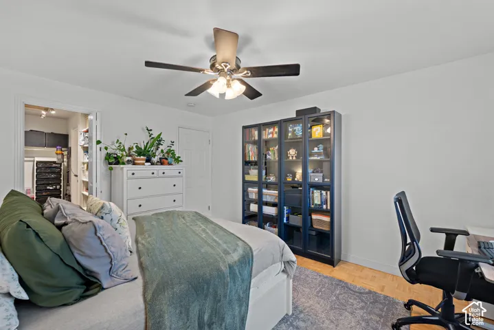Recessed lighting, wood-finish flooring, and a ceiling fan with integrated lighting