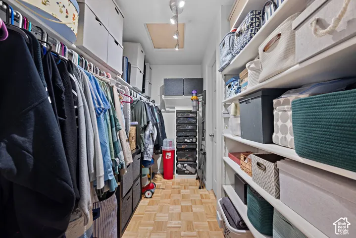 Parquet wood-finish flooring, recessed lighting, and extensive built-in shelving