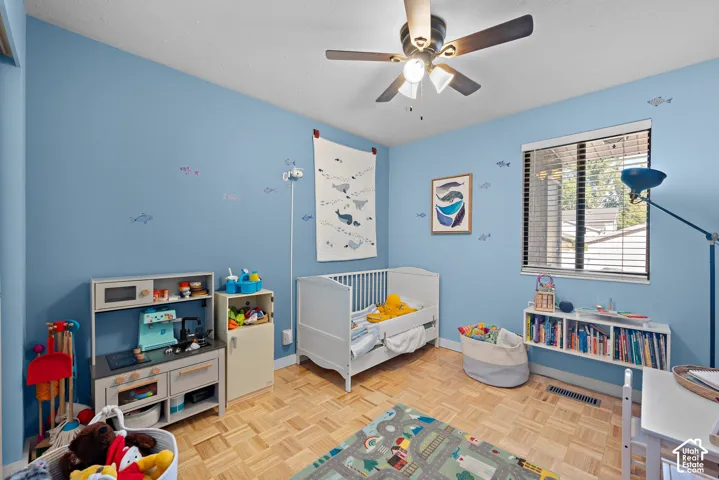 Light blue walls with a single window featuring horizontal blinds
