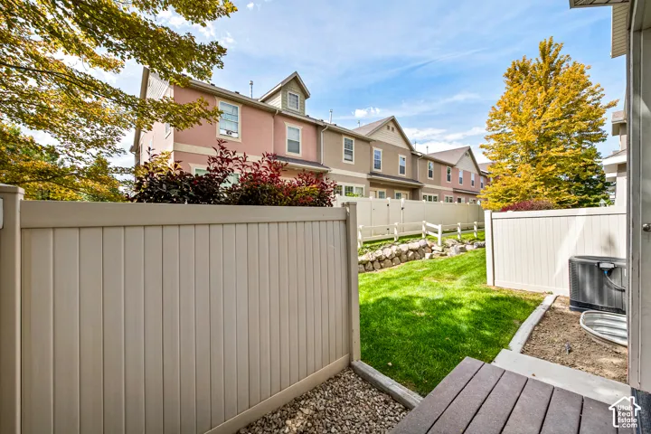 Private outdoor space featuring a composite deck, gravel border, and a manicured lawn