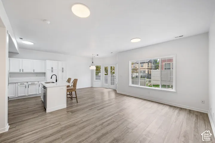 Open-concept living area with wood-finish flooring