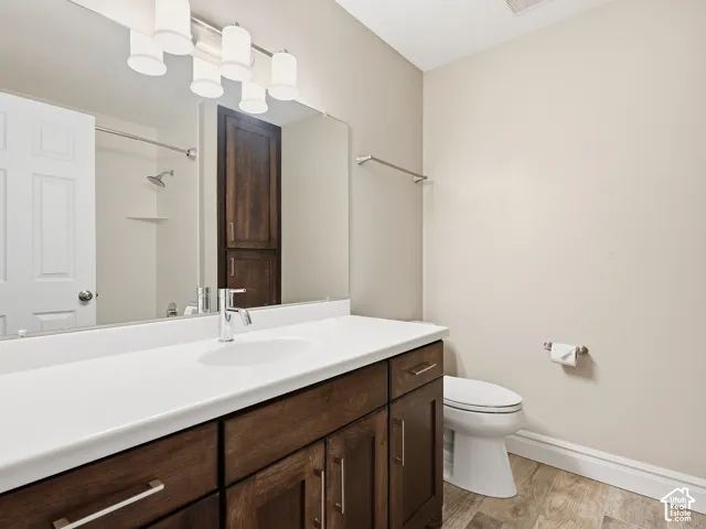 Spacious vanity with a white countertop and wood-finish cabinetry