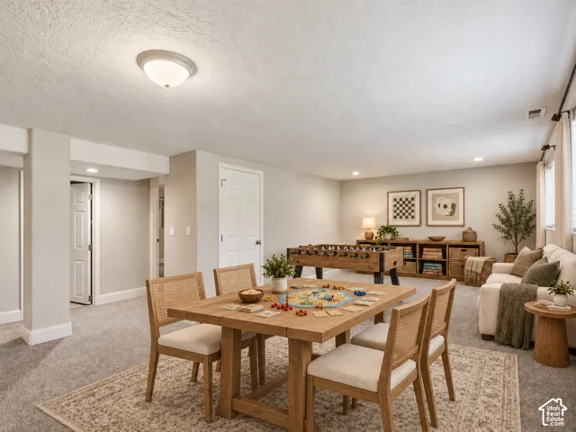 Spacious recreation room featuring recessed lighting, light gray carpeting, and light-toned walls