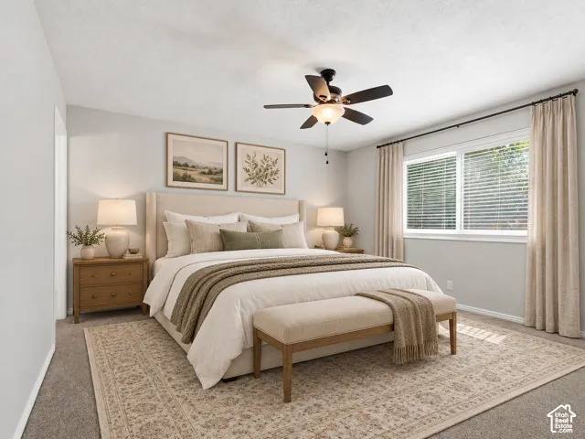Ceiling fan with integrated lighting, wall-to-wall carpeting, and a window with blinds