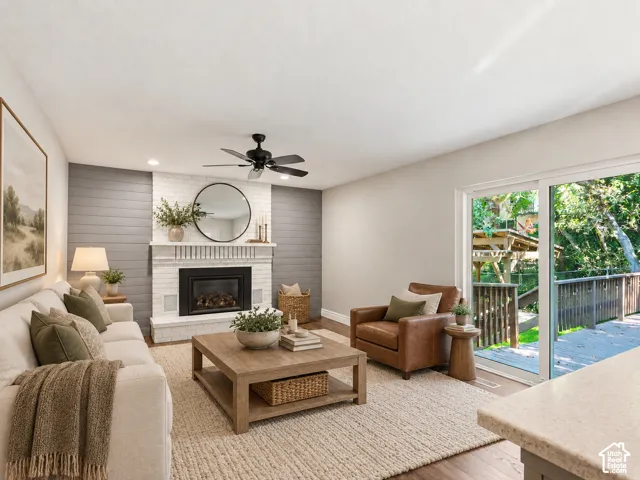 Fireplace featuring white brick surround and shiplap wall accent