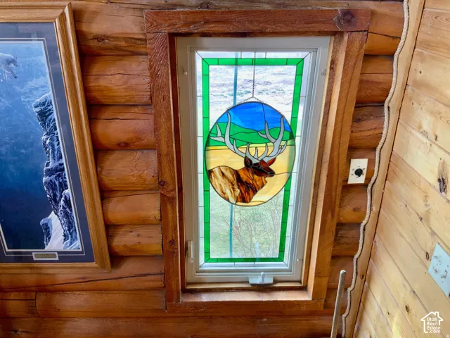 Log wall construction with a stained glass window feature