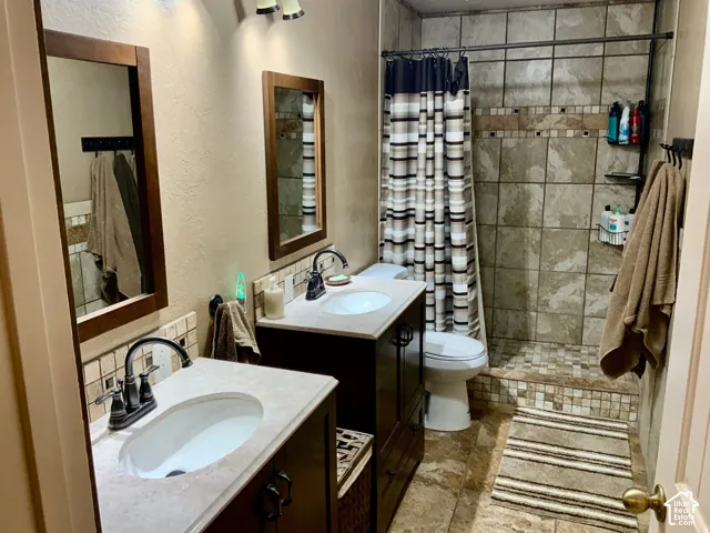 Dual vanity with undermount sinks and dark wood-finish cabinetry