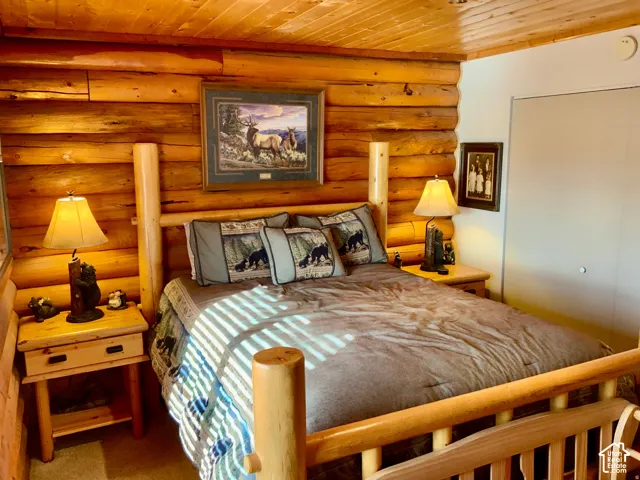 Log-style wood walls with a coordinating wood-paneled ceiling