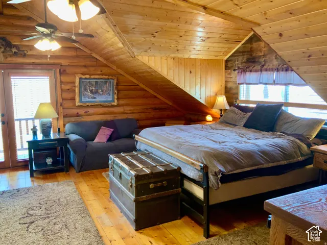 Wood-plank flooring with a log wall accent