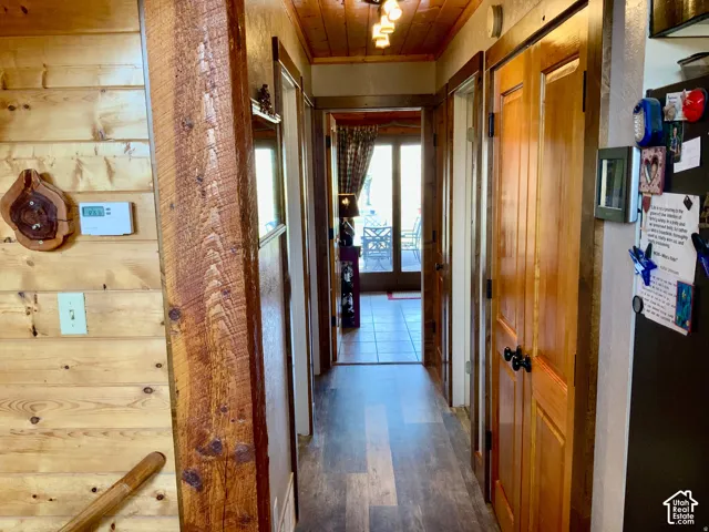 Wood-finish flooring, wood plank walls, and a wood plank ceiling
