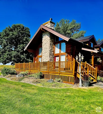 Log cabin exterior with a large stone chimney