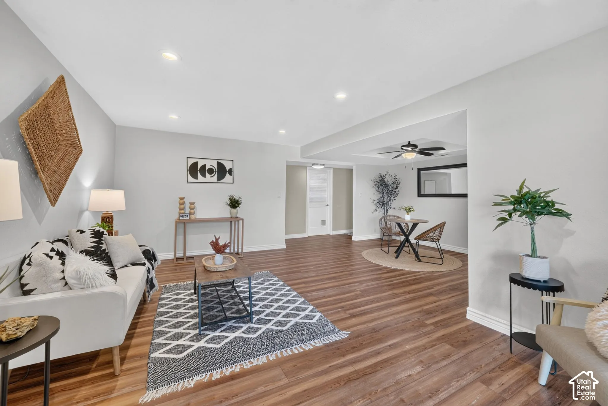 Living room seating area, with the dining area and hallway beyond.