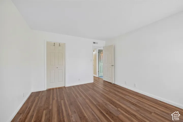 Wood-finish flooring throughout, white walls, and a white ceiling