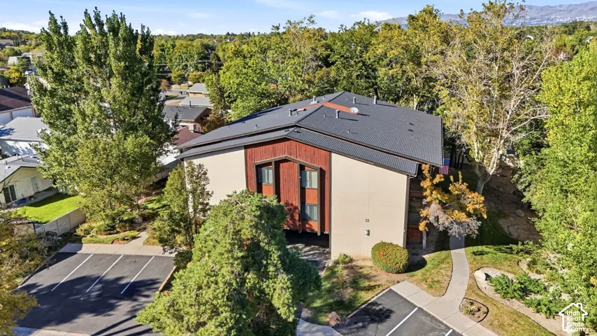 Another view of the building from above, surrounded by mature trees.