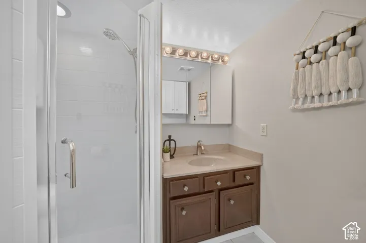 Glass-enclosed shower in the primary bath.