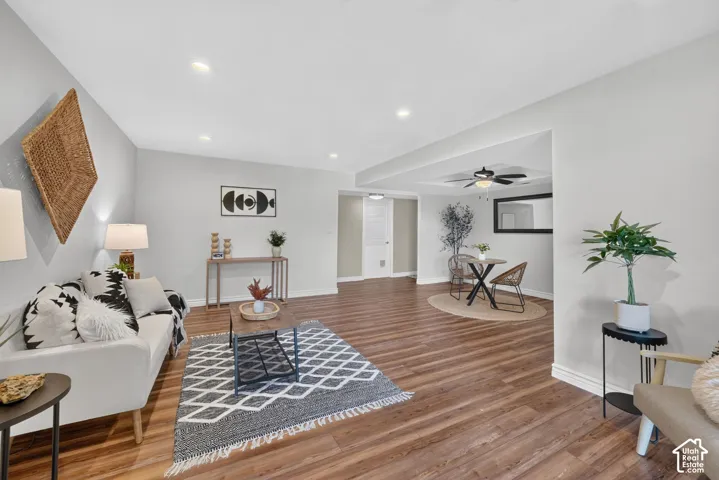 Living room seating area, with the dining area and hallway beyond.