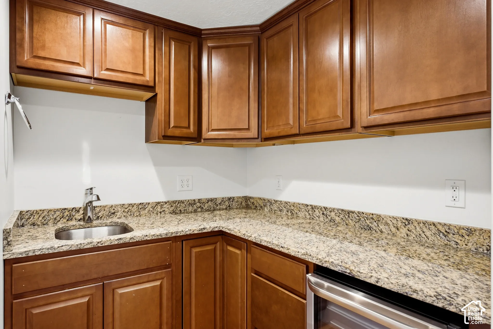 Wood-finish cabinetry paired with granite-style countertops