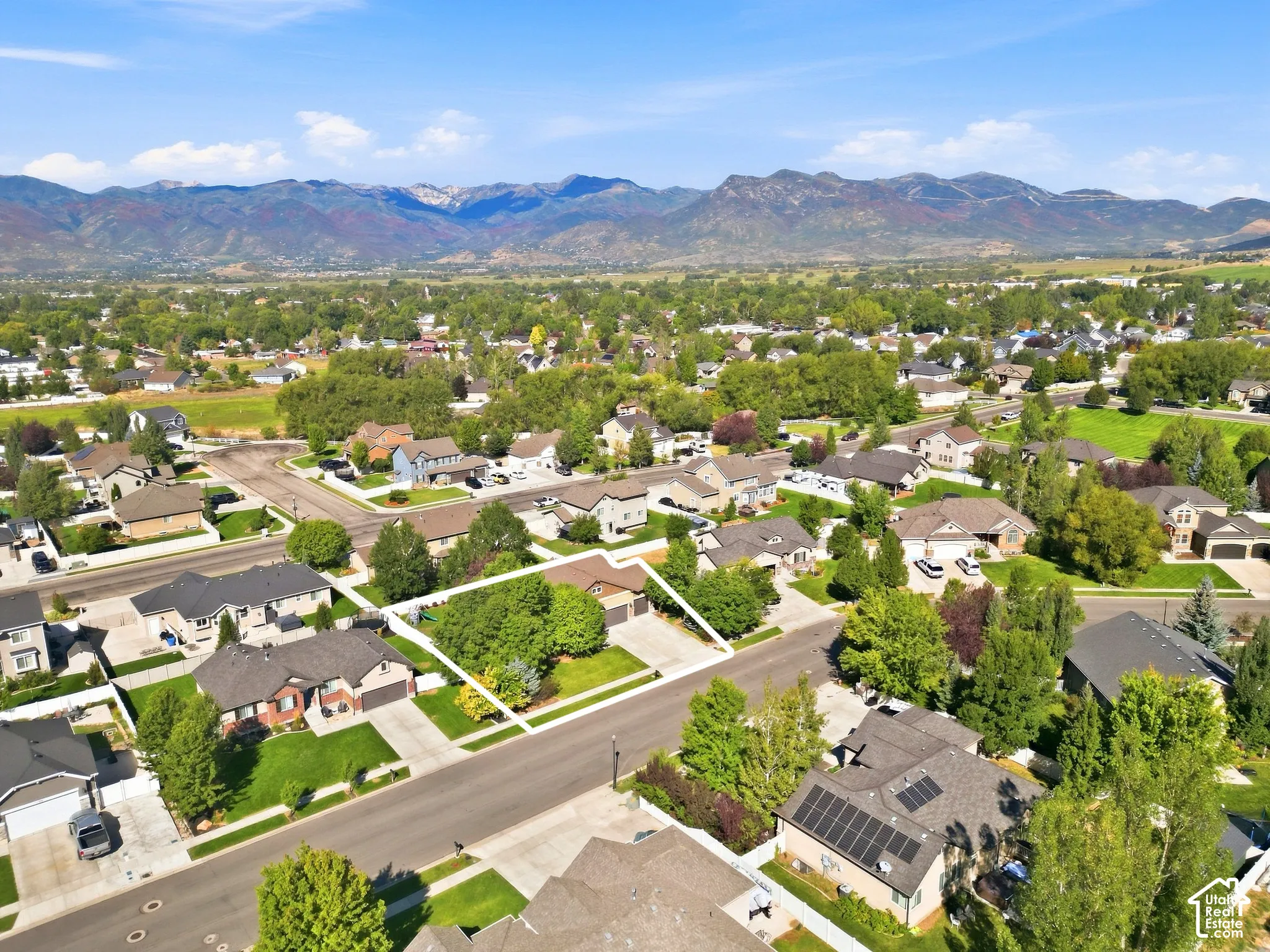 Residential neighborhood setting with mountain backdrop and mature trees