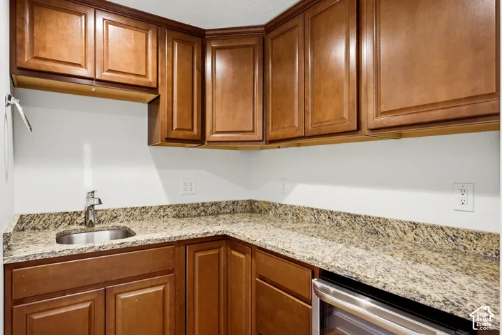 Wood-finish cabinetry paired with granite-style countertops