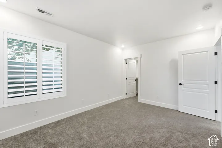Light gray carpet flooring, white walls, and white trim