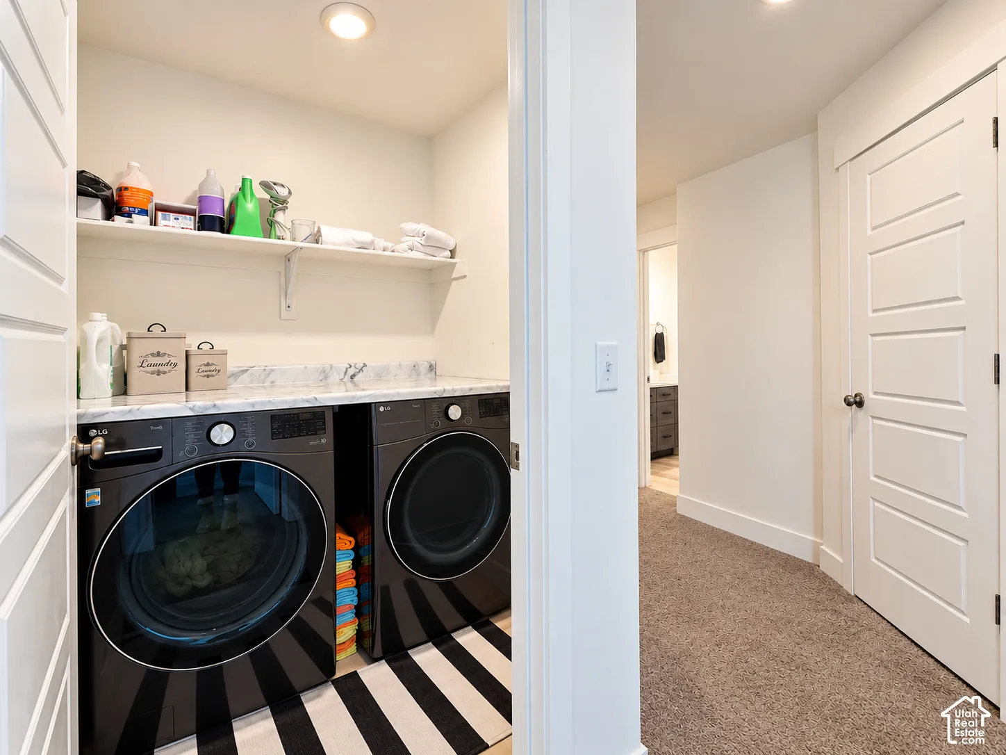Laundry area featuring a built-in counter, open shelving, and recessed lighting