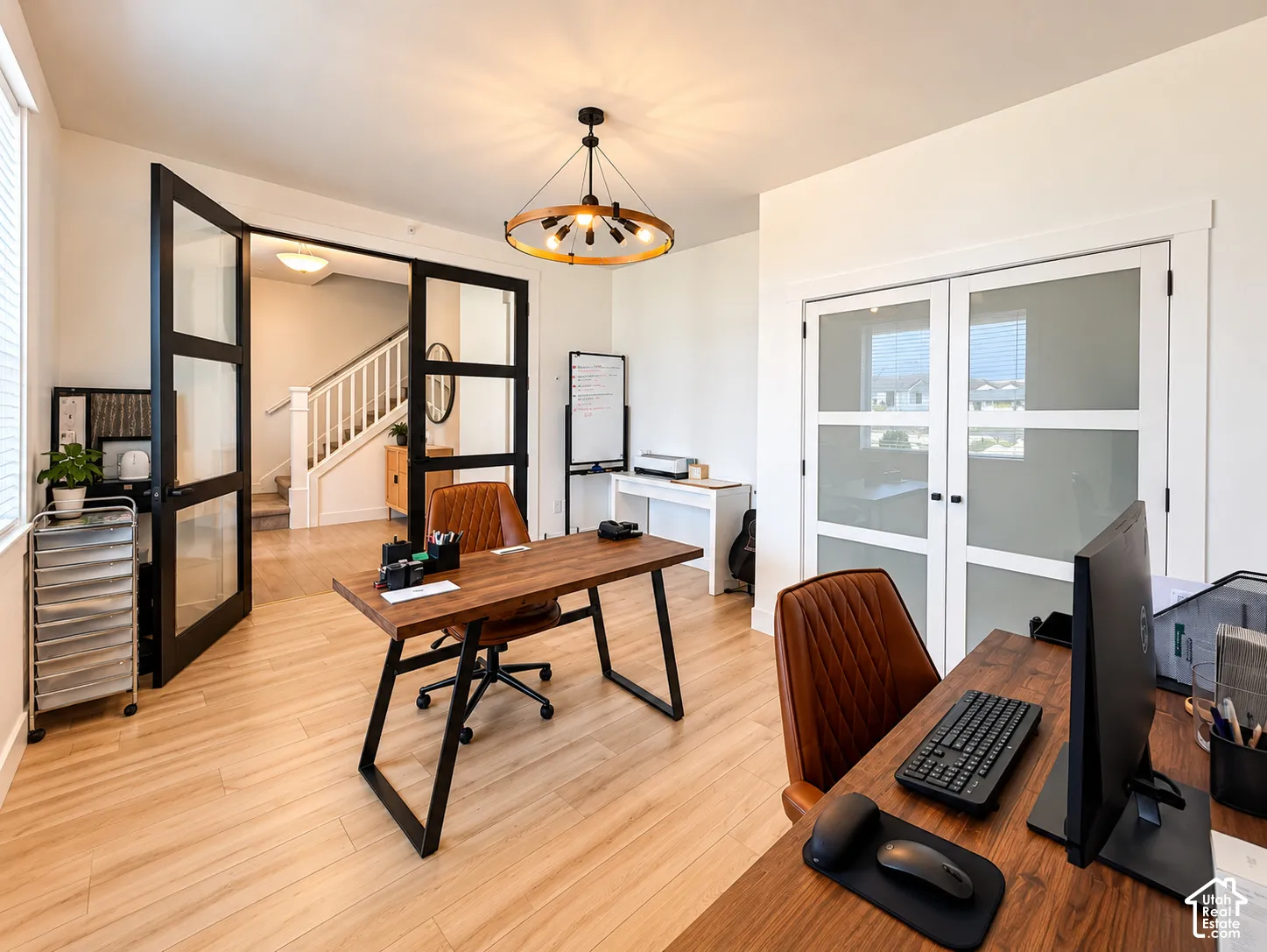 Wood-finish flooring throughout, complemented by a contemporary chandelier