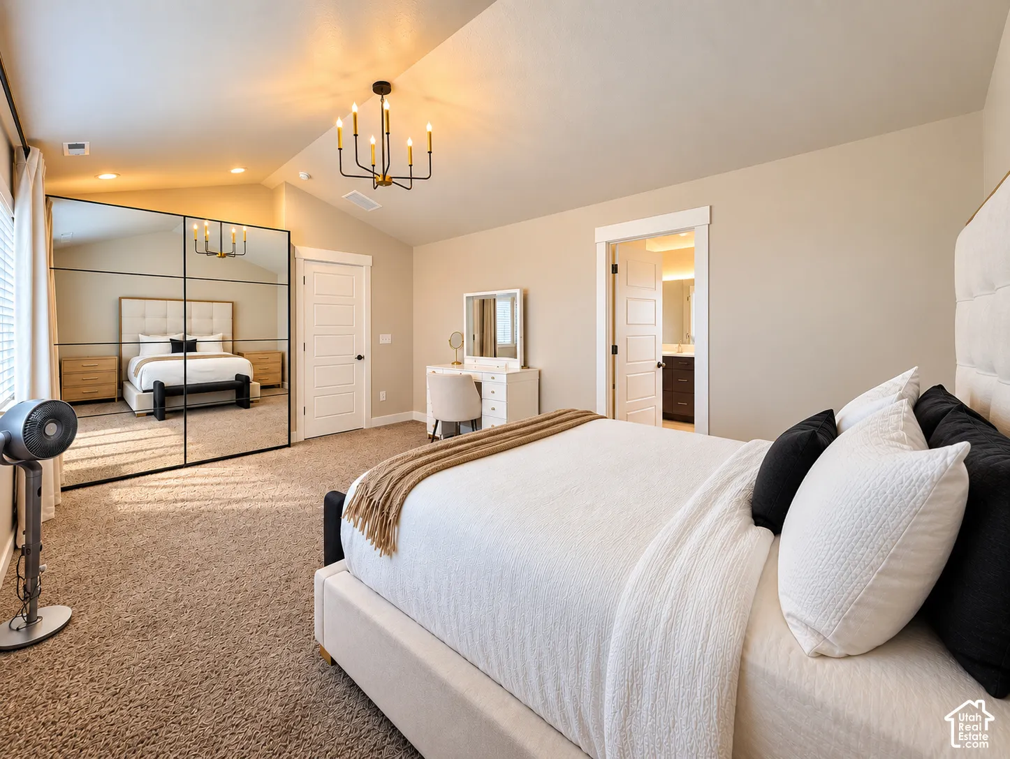 Angled ceiling with recessed lighting and a black finish chandelier