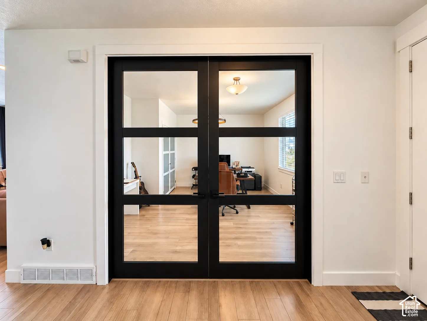 Wood-finish flooring, white walls, and a white ceiling