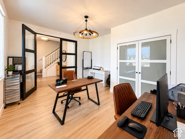 Wood-finish flooring throughout, complemented by a contemporary chandelier