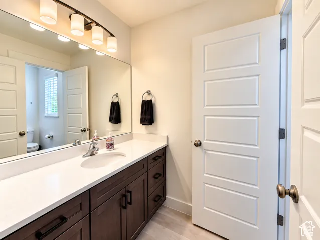 Spacious vanity with a white solid-surface countertop and integrated sink
