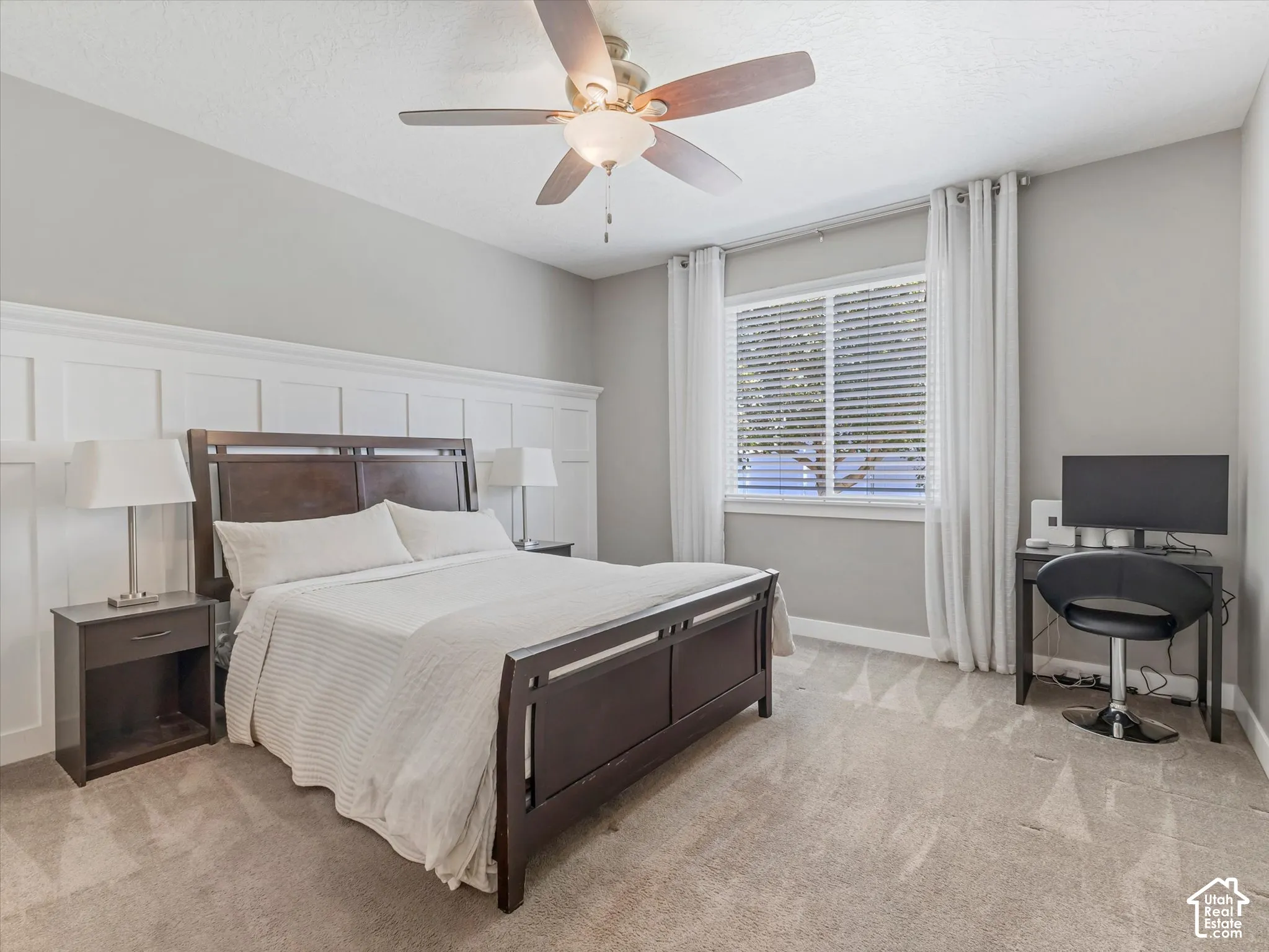 Board and batten wall accent, ceiling fan with integrated lighting, window with blinds and drapes, and neutral wall color