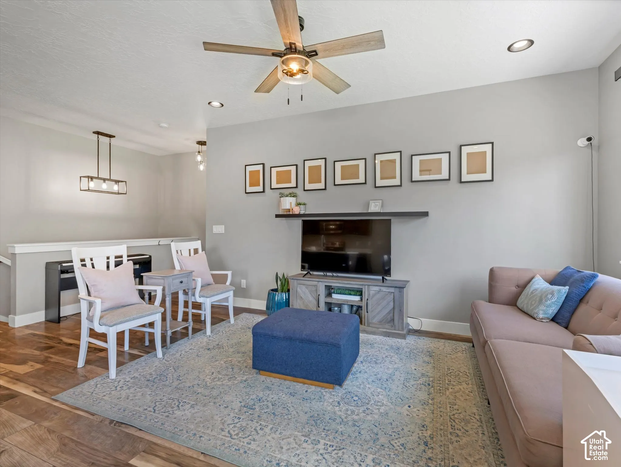 Wood-finish flooring with a ceiling fan light fixture and recessed lighting