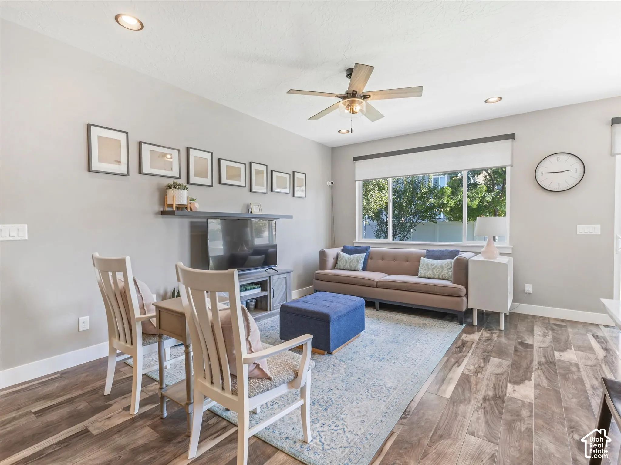 Recessed lighting, ceiling fan, large windows, wood-finish flooring, and white trim