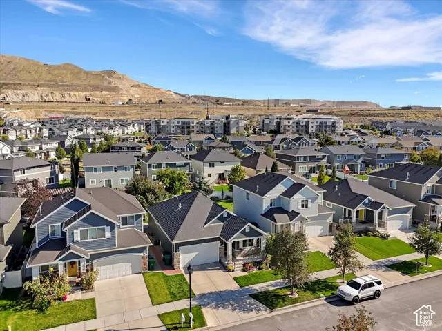 Residential neighborhood with varied architectural styles, a street network, and mountain range backdrop