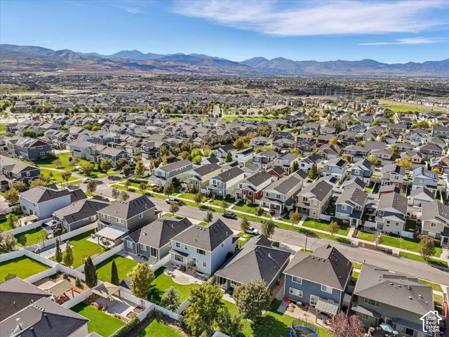 Residential neighborhood featuring diverse architectural styles and mature landscaping, with a prominent mountain backdrop