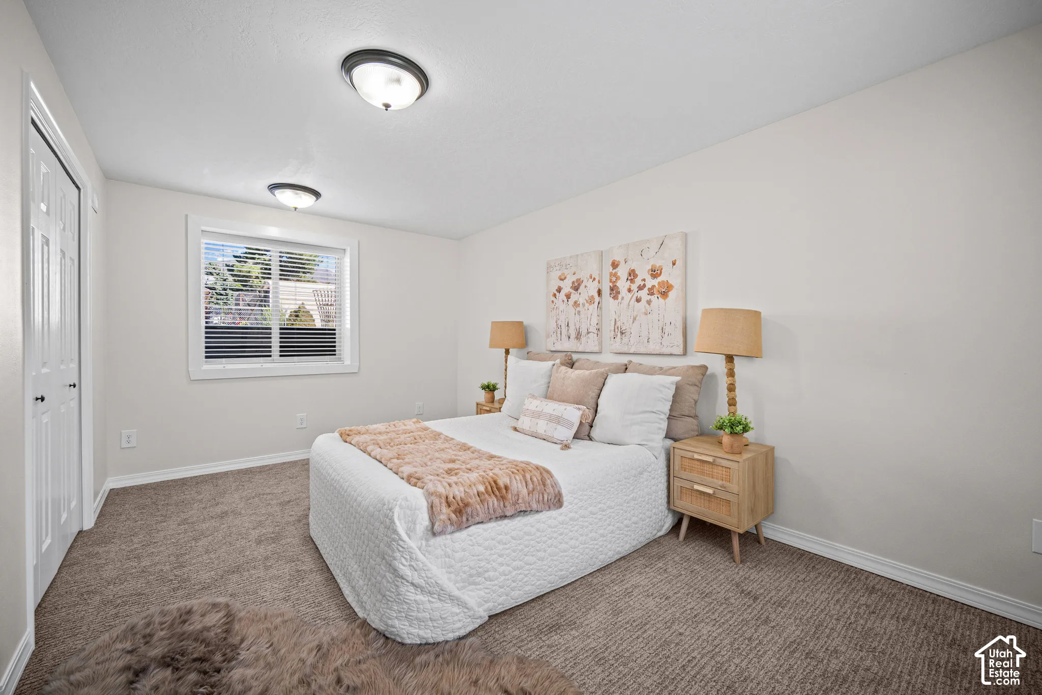 Neutral wall paint, textured carpet flooring, white trim window, and permanent ceiling light fixtures