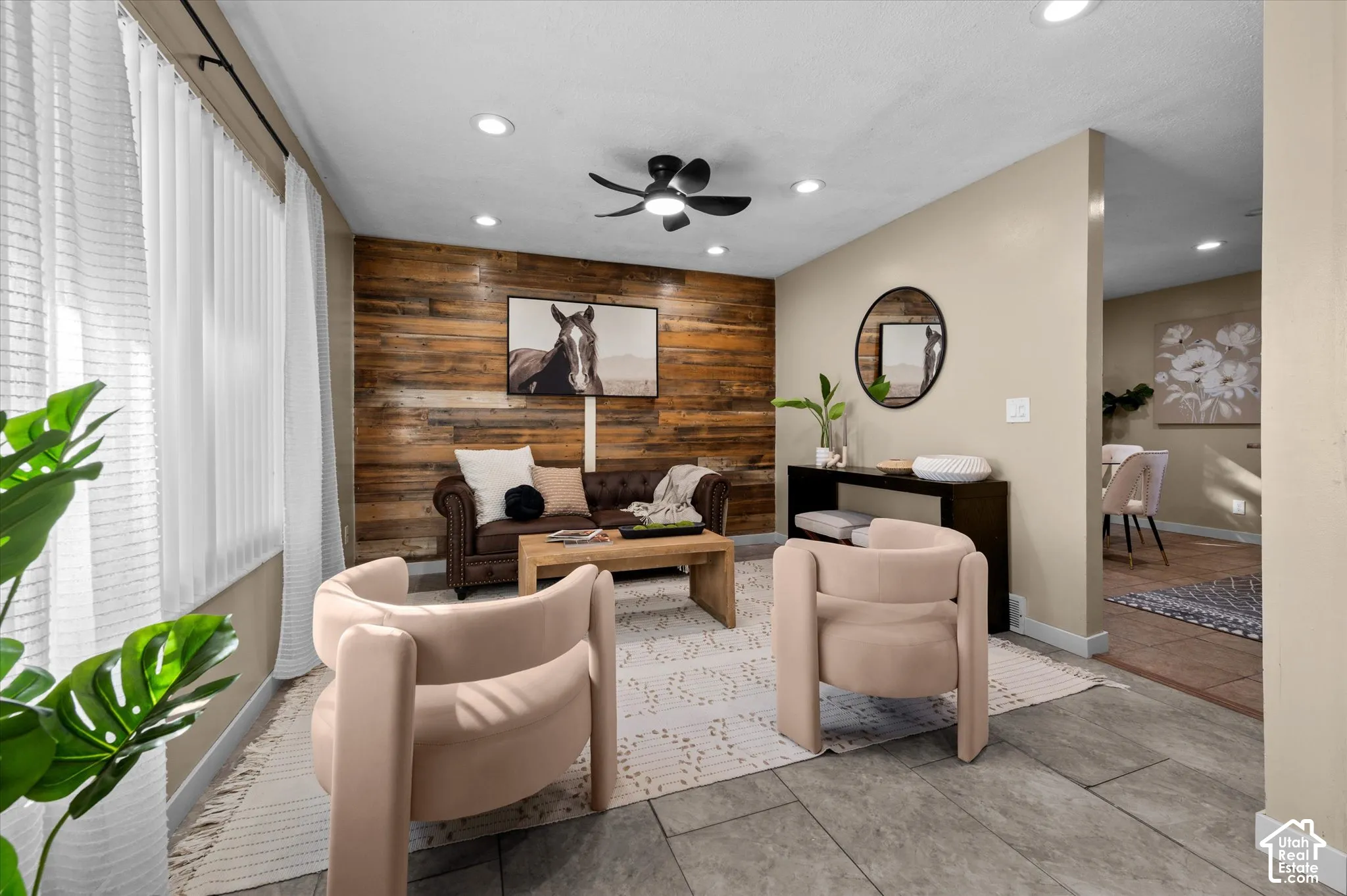 Reclaimed wood accent wall, recessed lighting, ceiling fan, and tile flooring