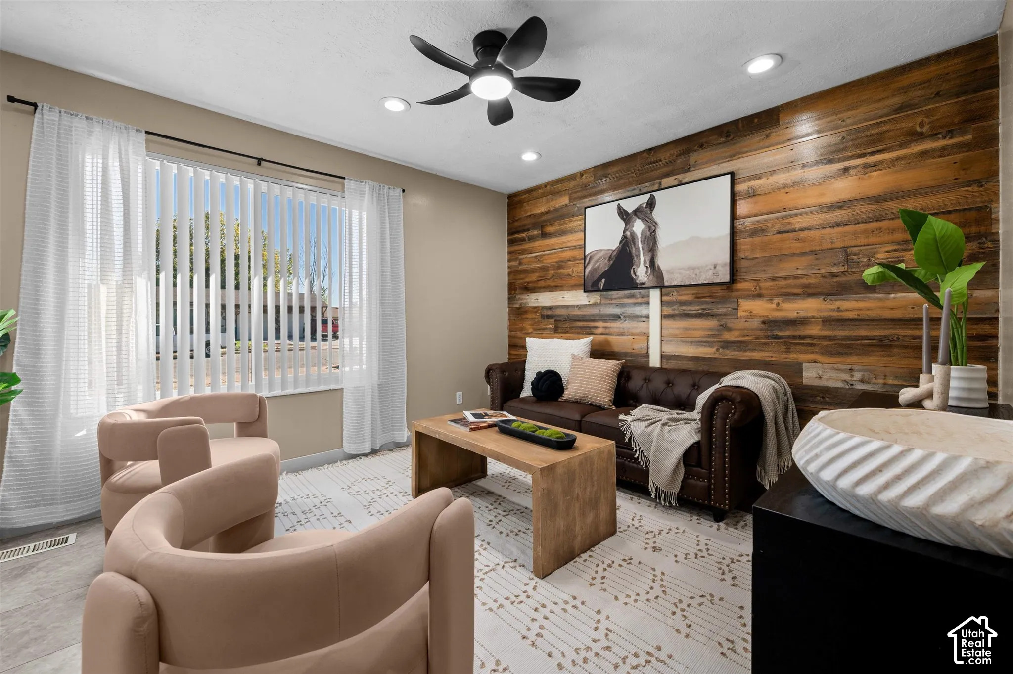 Accent wall featuring horizontal wood paneling, recessed lighting, and a ceiling fan