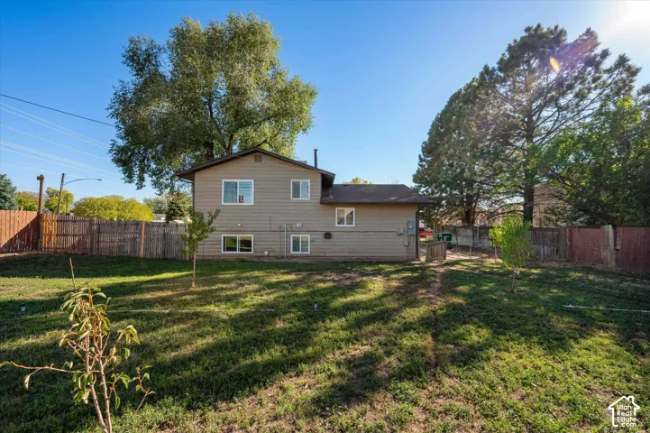 Spacious two-story home with vinyl siding exterior set on a large, level lot