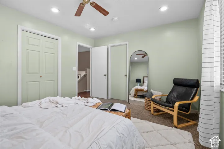 Carpeted flooring, recessed lighting, ceiling fan light fixture, paneled doors, and window with blinds