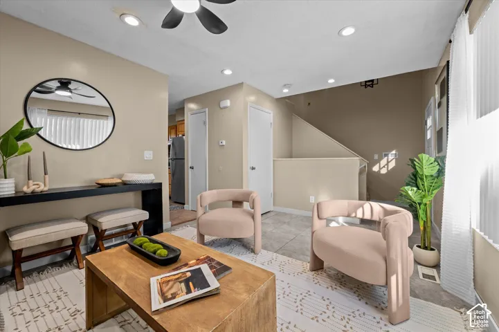 Recessed lighting, ceiling fan, and light wall tones