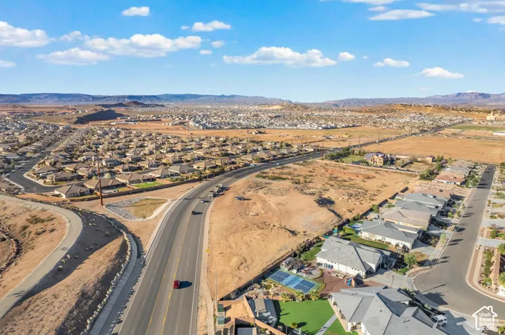 Expansive neighborhood setting with paved roads and distant mountainous terrain