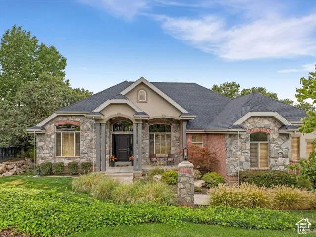 Stone and brick facade with a dark shingle roof