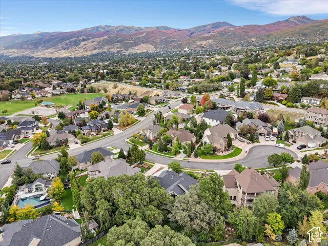 Mountain backdrop, residential neighborhood with winding streets, mature trees, and varying architectural styles
