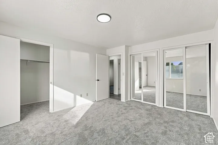 Light gray carpeting with a flat panel ceiling light
