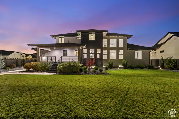 Expansive manicured lawn with landscape lighting and mature plantings