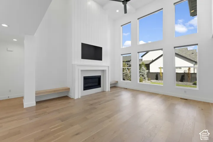 Spacious interior with high ceilings, recessed lighting, and expansive windows