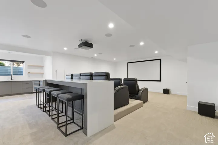 Built-in wet bar with gray cabinetry, integrated beverage refrigerator, and open shelving